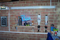 Here we see the Jack Daniels sign, strip light (For the Bar) along with a shelf containing some crap. Oh, and being a bar theres some drinks.