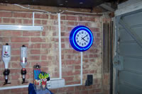Here we see a garage wall with a clock on it, and a garage door.